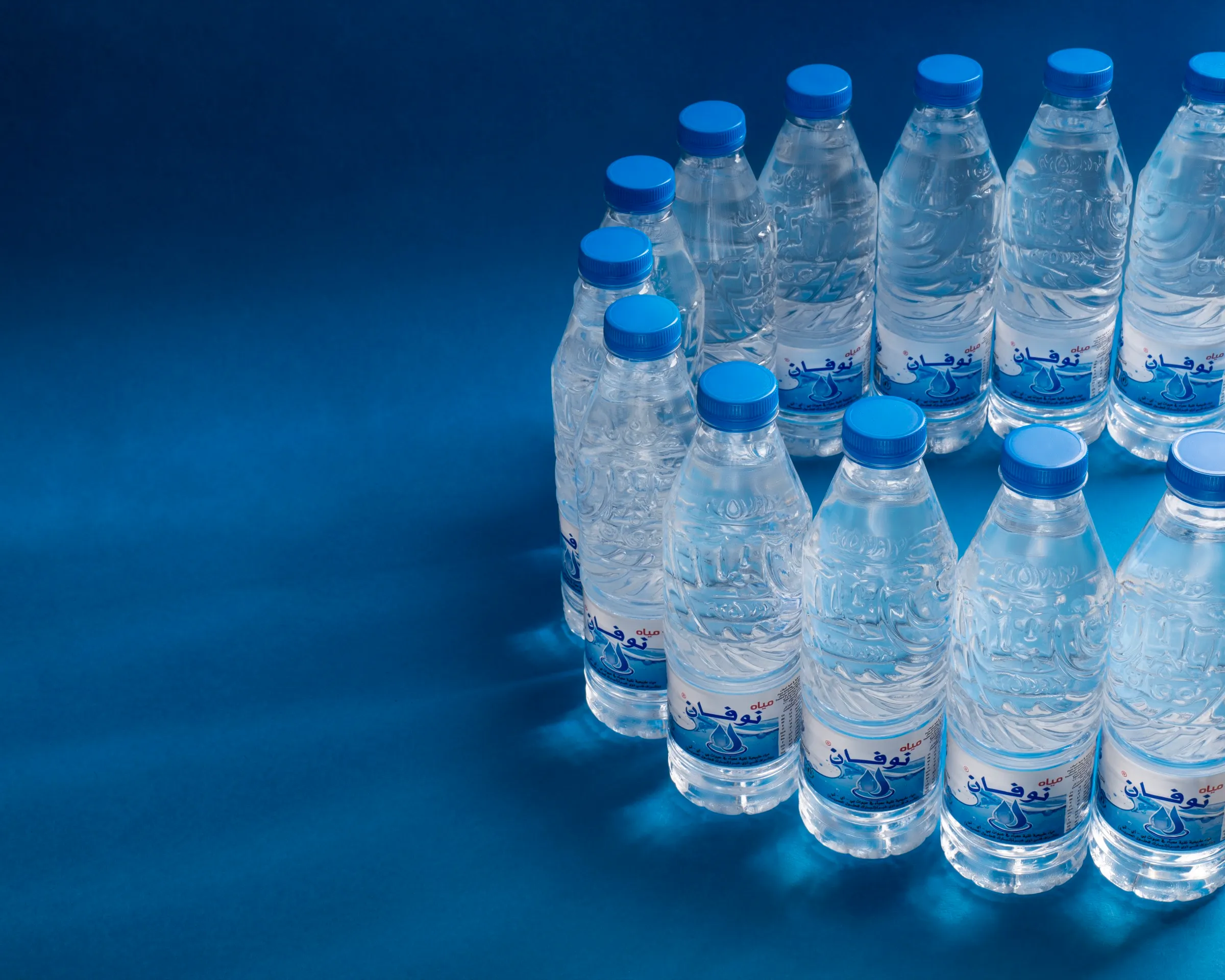 Novan bottles arced on deep blue under rays of light