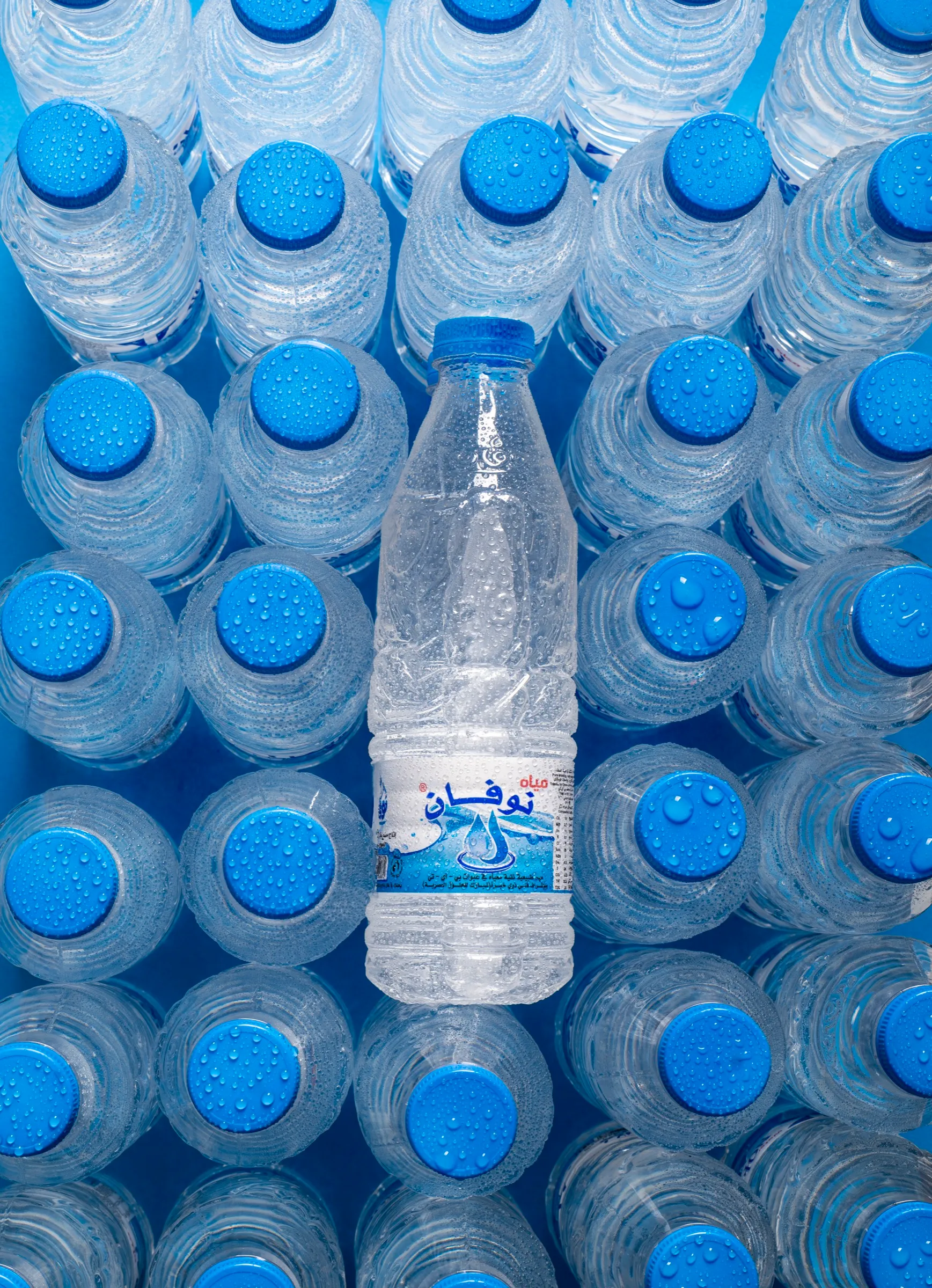Novan bottles seen from above, caps beaded with water